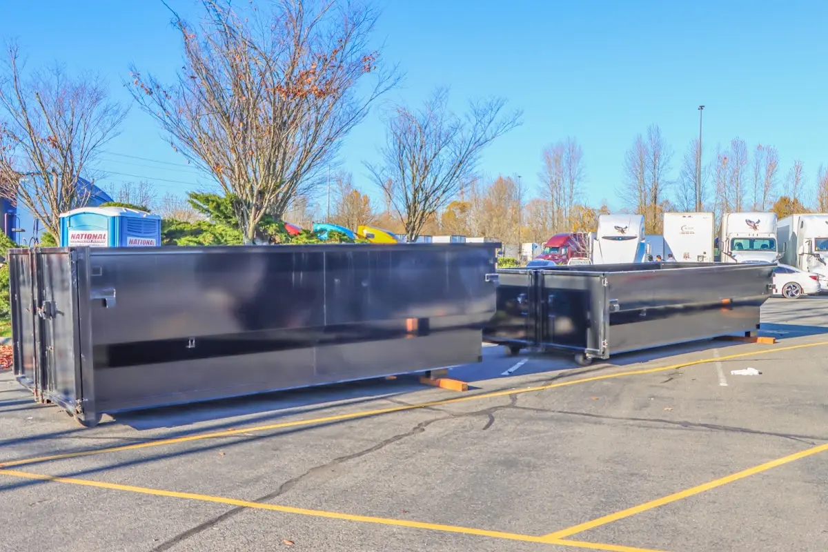 Professional dumpster rental service with roll-off container on residential driveway in Rosaryville